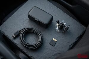 Rexing dash cam with mount, cable and memory card flat lay
